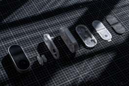 Security cameras for client ABUS, designed by Simon Busse Studio, disassembled on a black grid surface with dramatic lighting. 