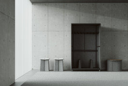 Minimalist room with Simon Busse DS-5010 stools for de Sede, open wardrobe, ottoman table, all on light gray carpet. 