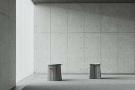 A minimalist room with DS-5010 stools by Simon Busse Studio, concrete walls, and a large window. 
