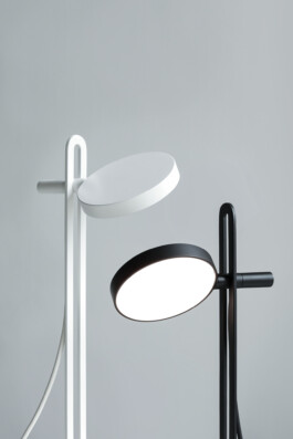 Two “Echo” table lamps by Simon Busse in white and black, minimalist design, close-up.
