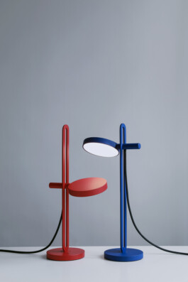 Minimalist “Echo” table lamps by Simon Busse in red and blue, placed side by side.